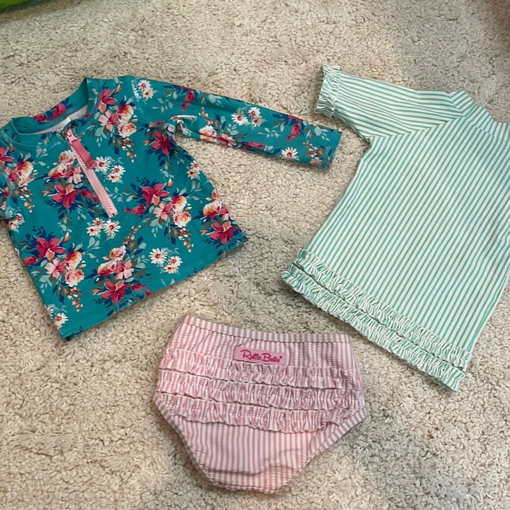 Ruffle butts swim suits. 1 bottom, 2 mix and match tops. Size 2T
